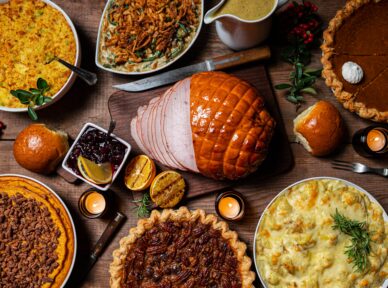 table filled with different Thanksgiving themed food dishes