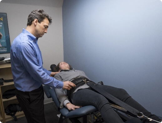 Dr. Todd administering spinal decompression therapy on a patient's lumbar spine