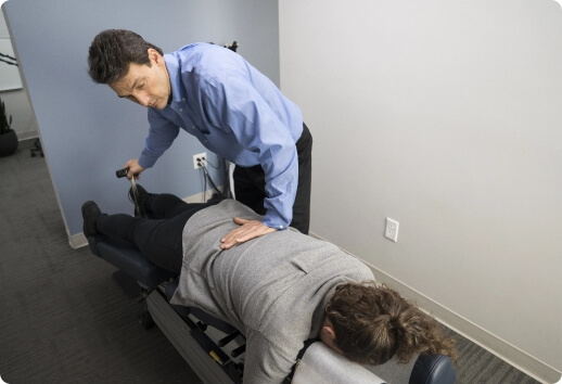 Dr. Todd administering flexion-distraction on a patient's lumbar spine