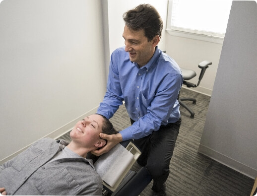 Dr. Todd administering a chiropractic neck adjustment