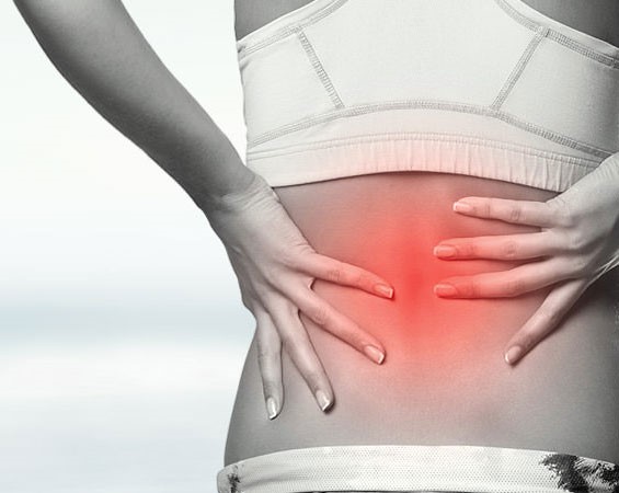 woman holding her back with a red area to indicate pain